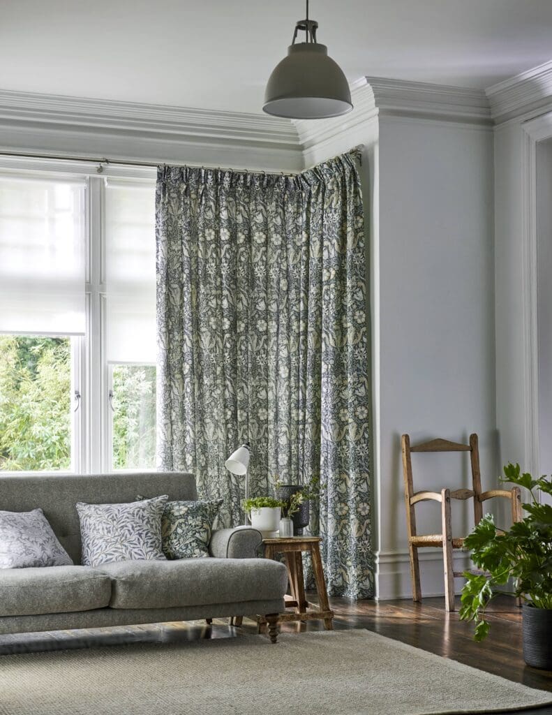 William Morris Honeysuckle and Tulip Velvet Gunmetal Curtains in a grey living room in a bay window